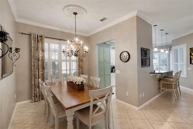 dining room with crown molding, visible vents, a notable chandelier, and light tile patterned flooring