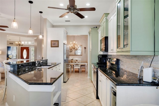 kitchen featuring a peninsula, glass insert cabinets, stainless steel appliances, and decorative light fixtures