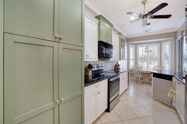 kitchen featuring dark countertops, white cabinetry, stainless steel appliances, and ornamental molding