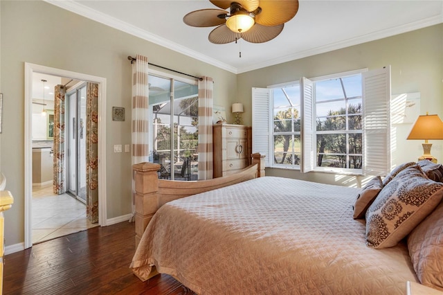 bedroom featuring dark wood-type flooring, a ceiling fan, baseboards, access to exterior, and ornamental molding