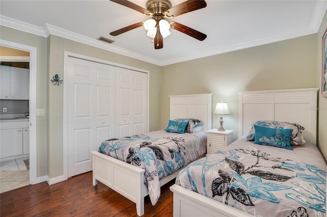 bedroom featuring visible vents, a ceiling fan, dark wood-style floors, crown molding, and a closet