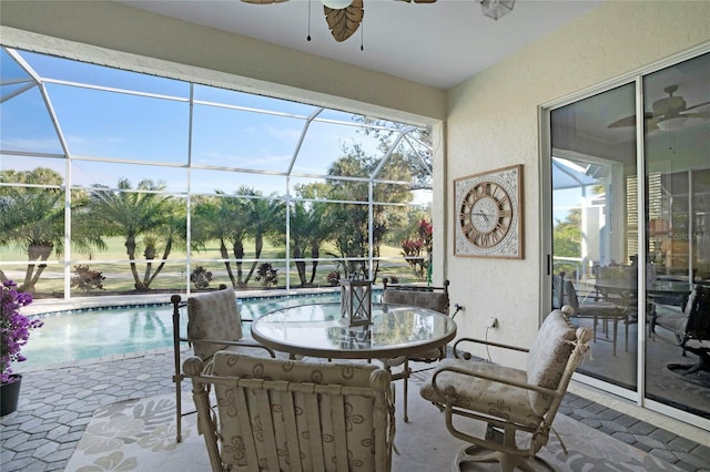 sunroom / solarium featuring ceiling fan