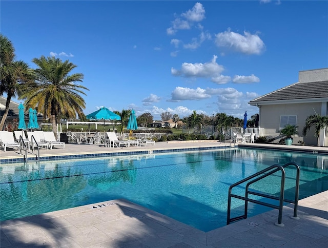 community pool featuring a patio area and fence