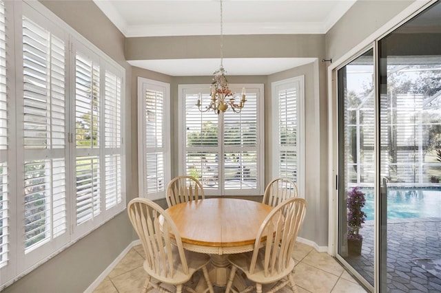 dining room with light tile patterned floors, ornamental molding, and baseboards