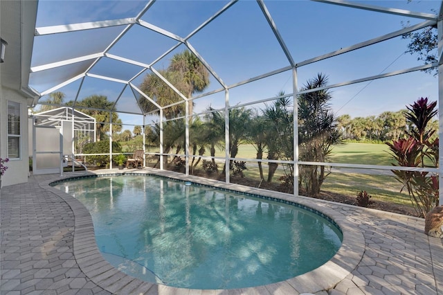 outdoor pool with a lanai and a patio