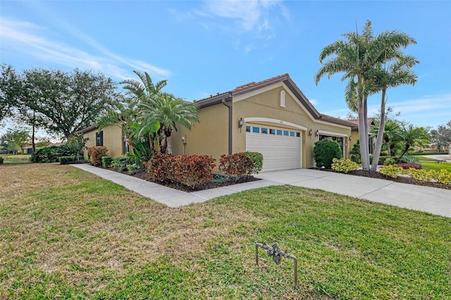 view of front of property with a garage and a front lawn