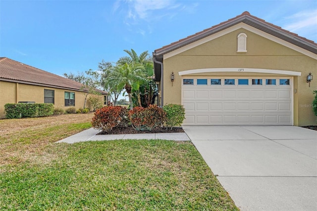 view of front of property with a garage and a front yard