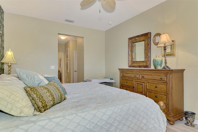 bedroom with ceiling fan and light hardwood / wood-style floors