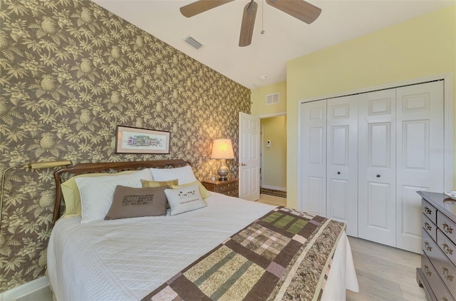 bedroom featuring ceiling fan, light hardwood / wood-style floors, and a closet