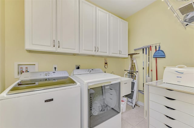 laundry room with cabinets, light tile patterned flooring, a wall mounted AC, and washing machine and clothes dryer