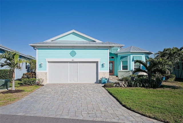 view of front of house with a garage and a front yard