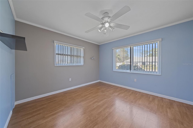 spare room featuring light hardwood / wood-style flooring, ornamental molding, and ceiling fan