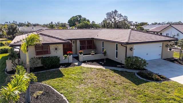 ranch-style home featuring a garage and a front lawn