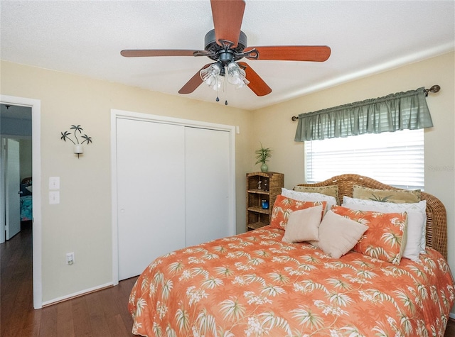 bedroom featuring ceiling fan, wood-type flooring, and a closet