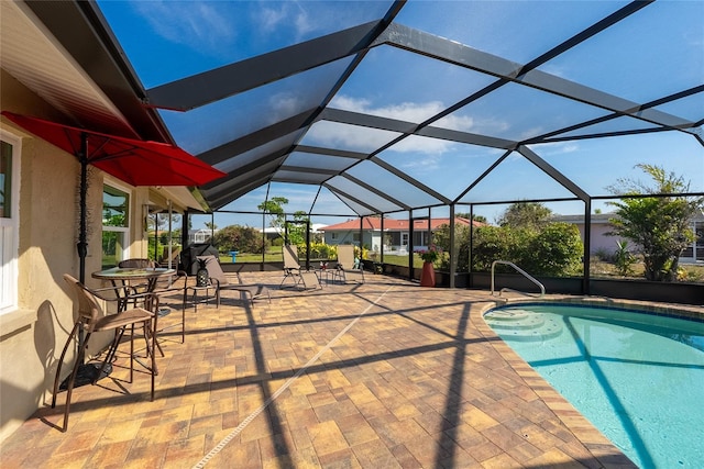 view of pool with a lanai and a patio area