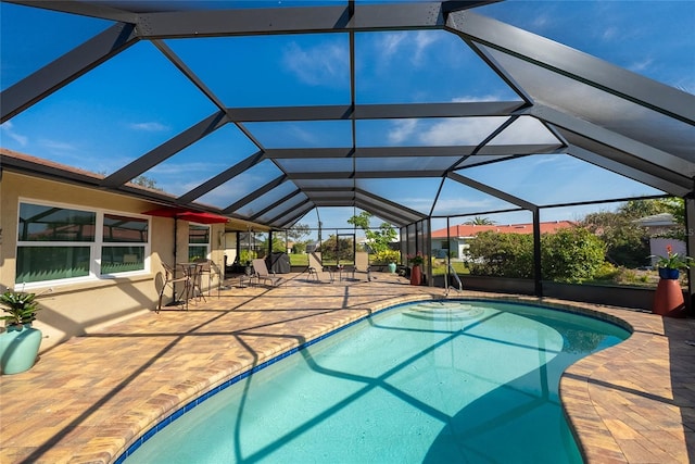 view of swimming pool featuring a patio and glass enclosure