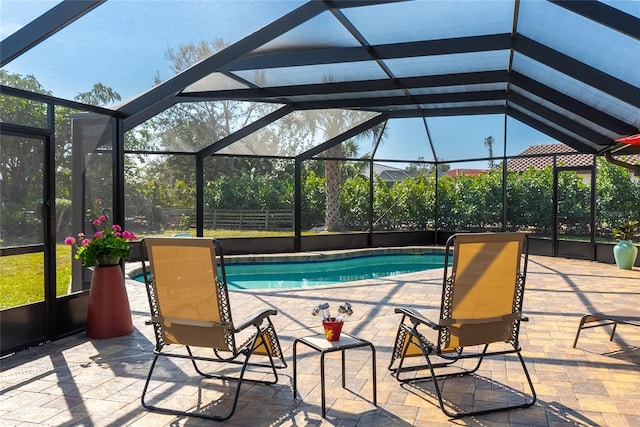 view of swimming pool featuring a patio and a lanai