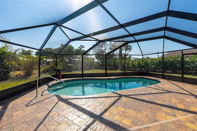 view of swimming pool featuring a lanai and a patio area