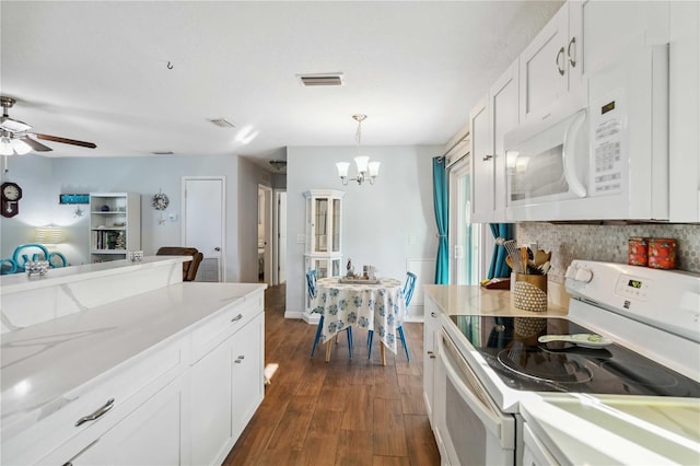 kitchen featuring ceiling fan with notable chandelier, white cabinetry, hanging light fixtures, dark wood-type flooring, and white appliances