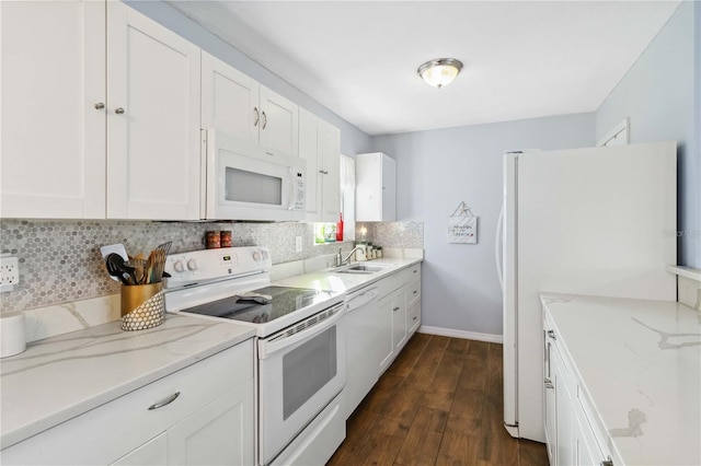 kitchen featuring light stone countertops, white cabinets, and white appliances