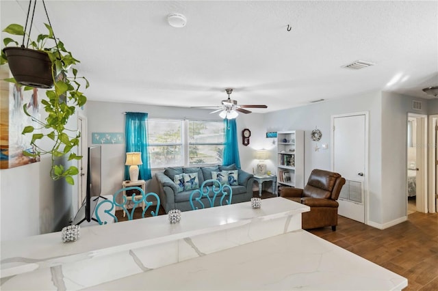 living room featuring dark hardwood / wood-style floors and ceiling fan