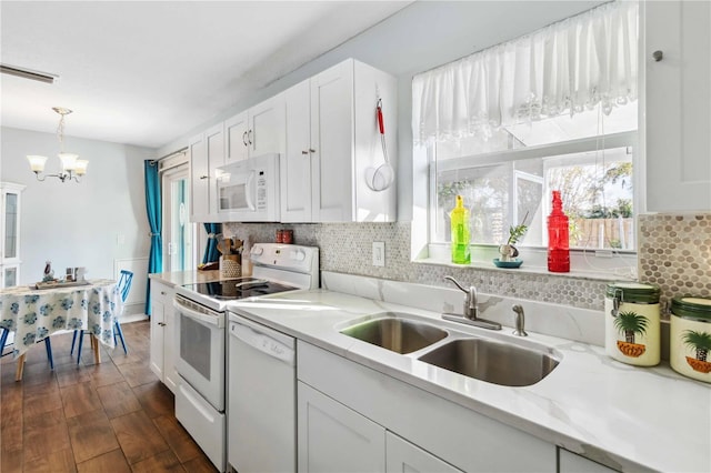 kitchen with sink, dark hardwood / wood-style flooring, white cabinets, white appliances, and backsplash