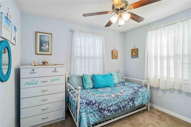 bedroom with multiple windows, carpet floors, and ceiling fan