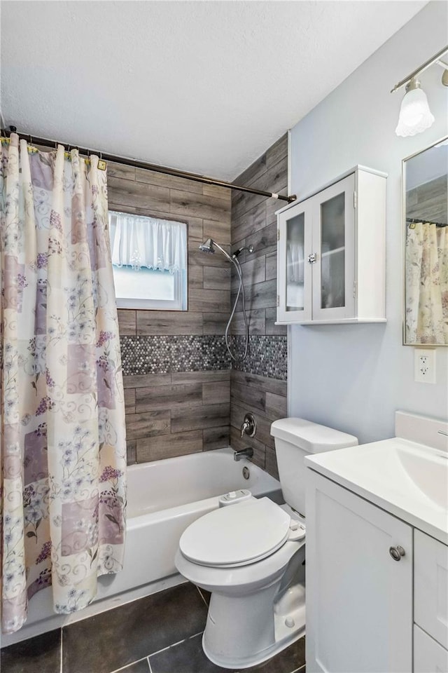 full bathroom with tile patterned flooring, vanity, toilet, shower / bath combo, and a textured ceiling