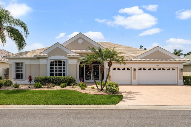 view of front of home with a garage and a front yard