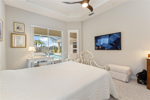 carpeted bedroom with a raised ceiling, crown molding, access to exterior, and ceiling fan