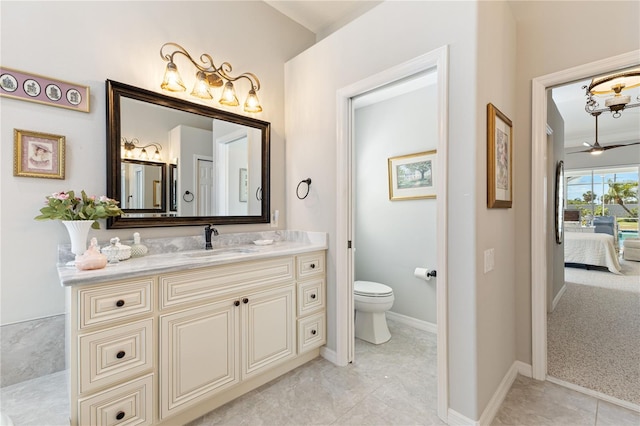 bathroom with tile patterned flooring, vanity, and toilet