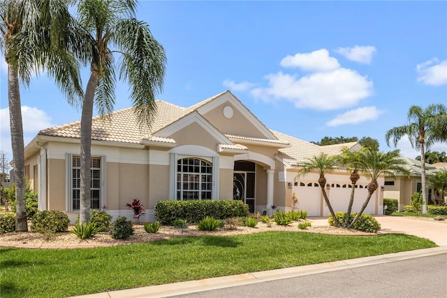 mediterranean / spanish-style house with a garage and a front yard