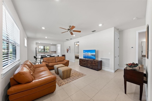 living room featuring light tile patterned flooring and ceiling fan