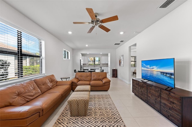 tiled living room featuring a wealth of natural light and ceiling fan