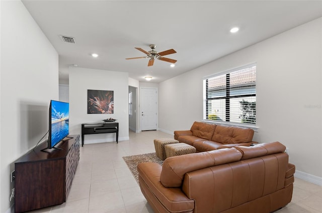 tiled living room with ceiling fan