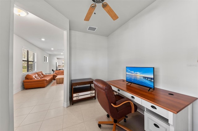 tiled home office featuring ceiling fan