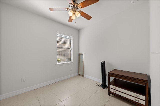 empty room featuring ceiling fan and light tile patterned floors