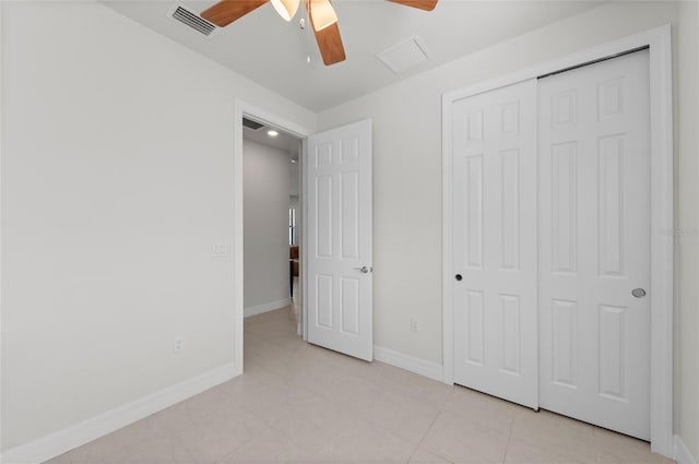 unfurnished bedroom with light tile patterned flooring, ceiling fan, and a closet