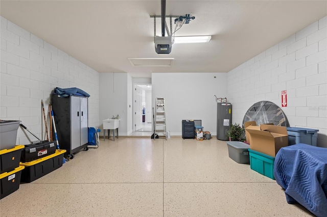 garage with a garage door opener, sink, and water heater