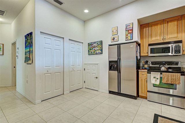 kitchen with appliances with stainless steel finishes and light tile patterned floors