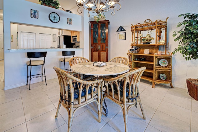 tiled dining space with an inviting chandelier