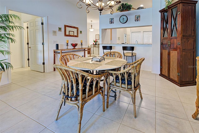 dining space featuring light tile patterned flooring and an inviting chandelier