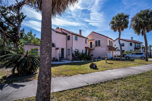 mediterranean / spanish-style home with a garage and a front yard