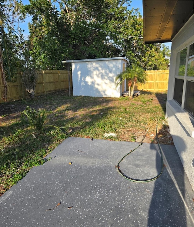 view of yard featuring an outdoor structure and a patio area