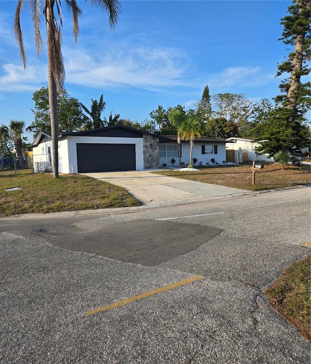 single story home featuring a garage and a front yard