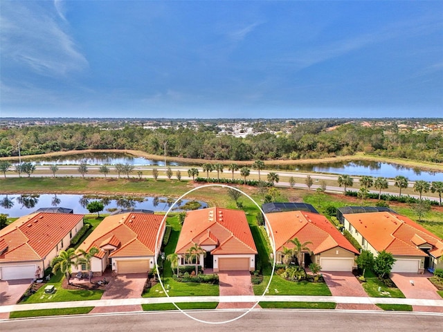 birds eye view of property with a water view