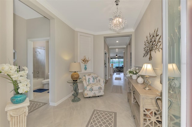 hallway with crown molding, light tile patterned flooring, and a notable chandelier