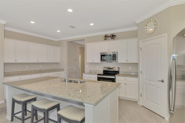 kitchen featuring white cabinetry, sink, a kitchen island with sink, light stone counters, and stainless steel appliances