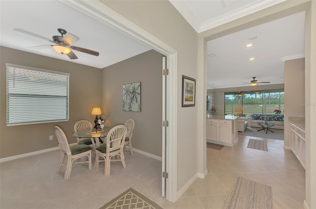 tiled dining area featuring crown molding