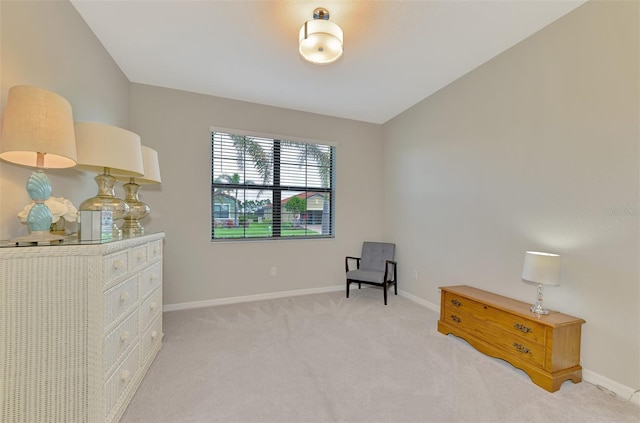 living area featuring light colored carpet and lofted ceiling